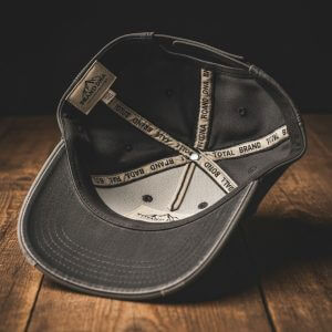 Bespoke vintage hat showing custom interior labels and branded taping for 100-piece orders.